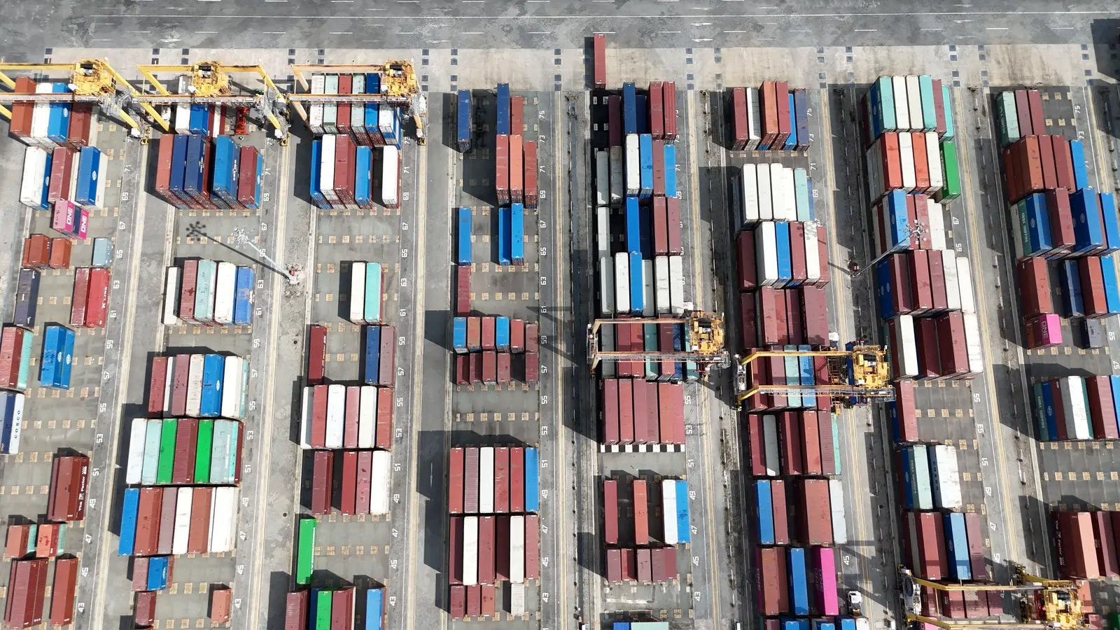 Aerial view of a container yard with cranes